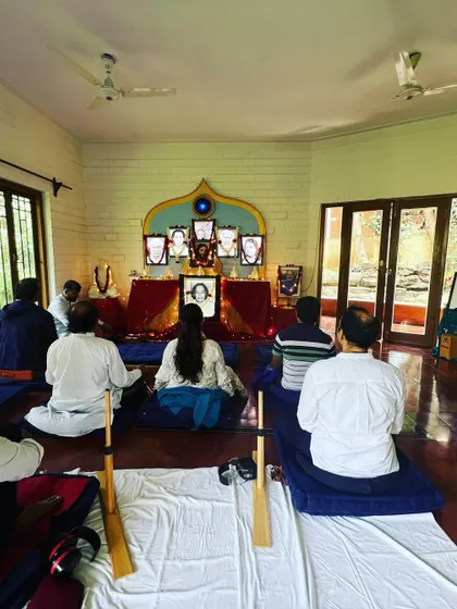Another view of our Christmas meditation, showing the group from behind as they face the beautifully decorated altar. The use of meditation benches and cushions ensures comfort during longer periods of silent sitting.