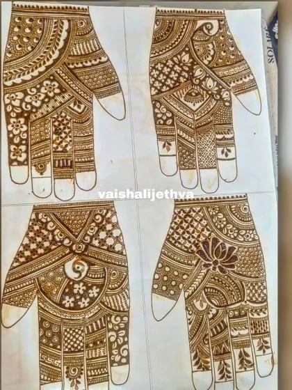 Practicing different palm designs on paper. This helps me refine my patterns and offer a variety of options to my clients.