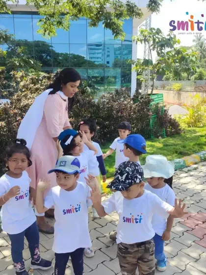A teacher guides the children on their walk around the lake, ensuring their safety and pointing out interesting natural features.