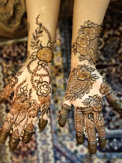 Another view of the complementary floral designs, showing how different patterns on each hand can create a beautiful and personalized look.