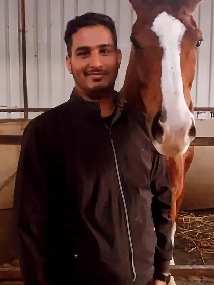 A member of our team posing with Vikrant, one of our favorite horses. This shows the close bond we have with our animals.