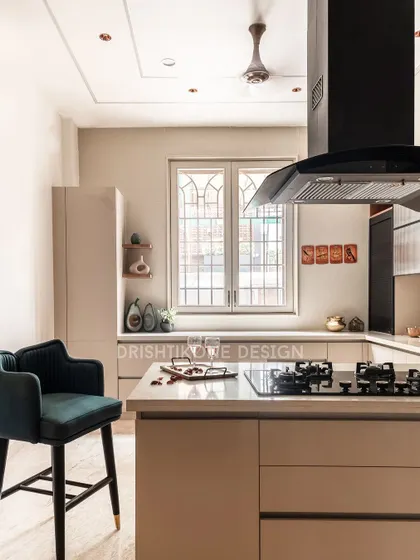 A detail shot of the kitchen's breakfast bar, complete with a stylish teal velvet bar chair. This little corner is perfect for a morning cup of coffee or a quick chat while cooking.
