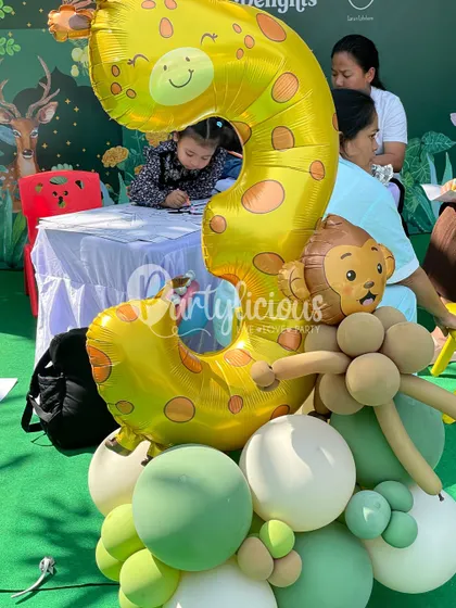 A close-up of a jungle-themed number '3' balloon bouquet, perfect for a little one's birthday at our festival booth.