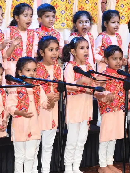 Our youngest performers, singing their hearts out on stage. The discipline and joy they exhibit is a result of months of dedicated practice.