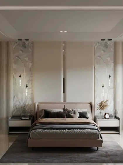 Symmetry and luxury define this bedroom. Two large marble panels flank the bed, each with its own minimalist wall sconce. The clean lines, neutral color palette, and uncluttered surfaces create a serene and highly sophisticated atmosphere.