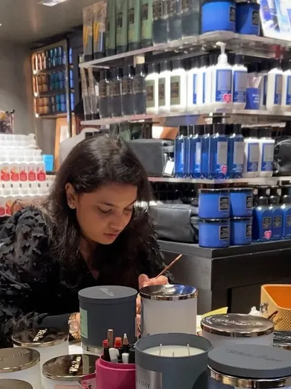 A candid shot of me in action, focused on hand-painting a scented candle at a Bath & Body Works event. I treat every item with care, ensuring the final result is something the customer will love.