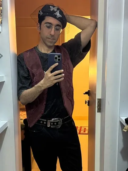 Another view of our client's styled outfit. You can see the full look here with the velvet vest, statement belt, and butterfly beret. This shows the versatility of our rental accessories.
