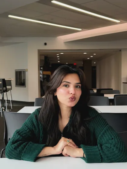 A cute, playful pose in the library or a study hall.