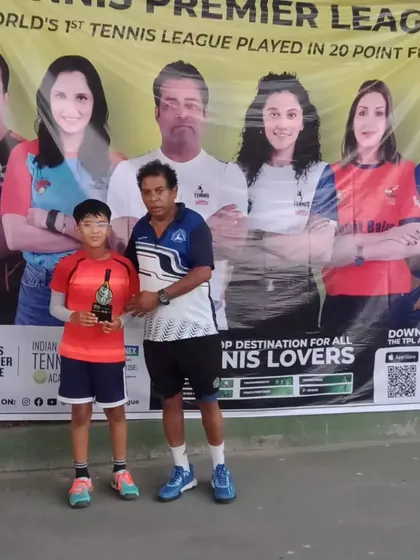 A junior player receives his winner's trophy at the conclusion of the TPL-ITA tennis tournament. Our staff ensures a smooth and memorable awards ceremony for all winners and finalists.