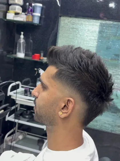 A textured mohawk with a high fade.