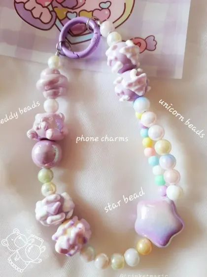 A close-up of one of my favorite purple phone charms. I've used a mix of teddy beads, unicorn beads, and a big star bead to create this super cute, pastel accessory.