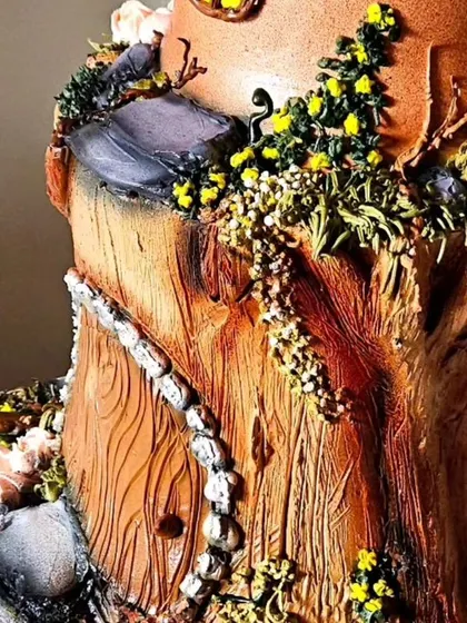 A detail shot of the base of the mushroom house cake, showing the intricate root and stone textures I created using only whipped cream and piping techniques.