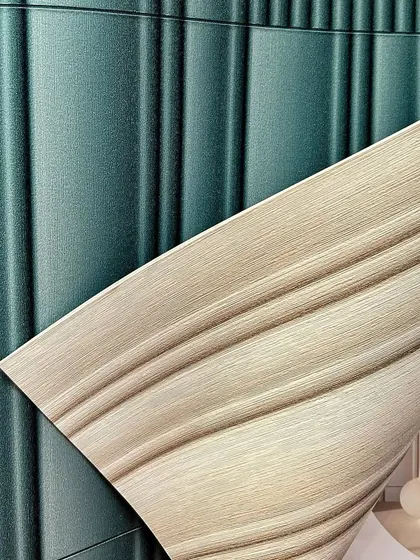 This 3D textured wallpaper in a deep teal and a neutral beige adds a modern, sculptural element to your walls. The fluted design creates a dynamic play of light and shadow.