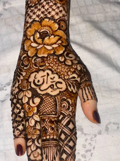 A close-up of the palm showing the name "Imran" beautifully integrated into the floral design.