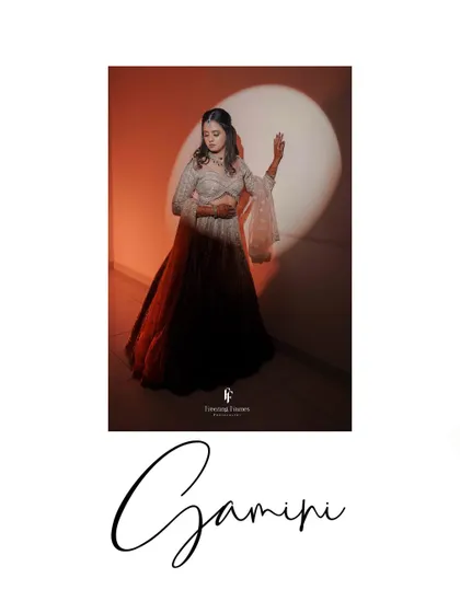 A stylish portrait of the bride, Gamini, in her reception lehenga, illuminated by a single spotlight.