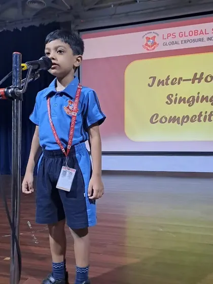 A student from the blue house sings his piece during the competition.
