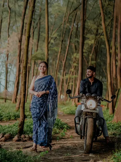 A stylish pre-wedding shot in a forest setting, featuring the couple with a motorcycle for a cool, rustic vibe. We love incorporating props that tell your story.