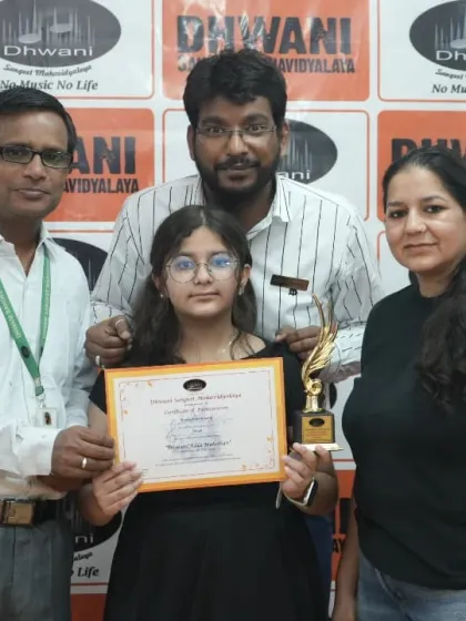 A student with her family and teachers, a complete circle of support celebrating her musical achievement.