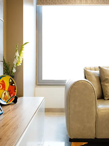 A close-up of the TV unit, showing the clean lines and a pop of color from the decorative plate, adding a personal touch to the minimalist design.