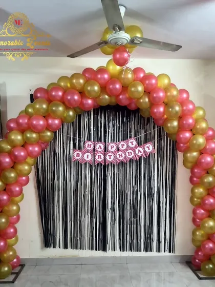 A classic balloon arch with a shimmer curtain backdrop, perfect for creating a simple photo corner at home.