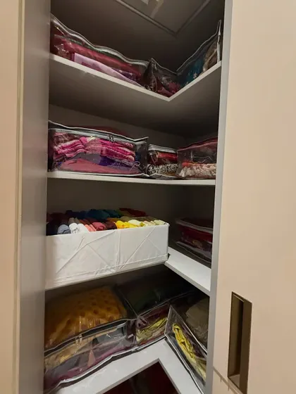 We make use of every corner. This L-shaped shelf is perfect for storing seasonal or heavy festive wear in protective, clear-front bags.