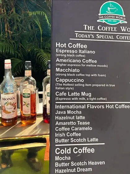 The detailed menu for "The Coffee World," listing a wide variety of specialty coffees and teas.