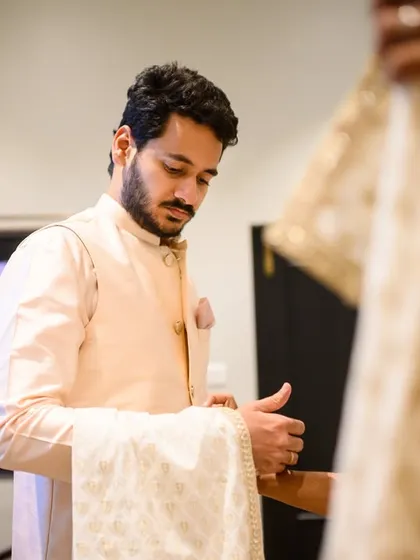 A candid shot of the groom, Akshay, getting ready. These behind the scenes moments are an important part of the wedding story.