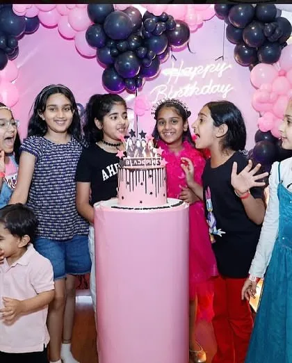 All the friends gather around the Blackpink-themed cake, excited to celebrate their friend's special day.