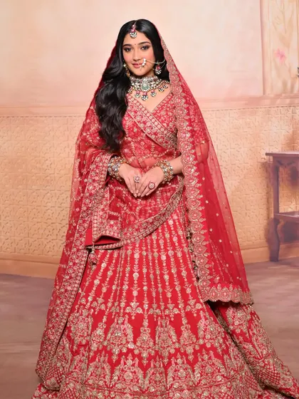 The complete royal bridal look, showcasing the magnificent red lehenga and the regal makeup and styling.