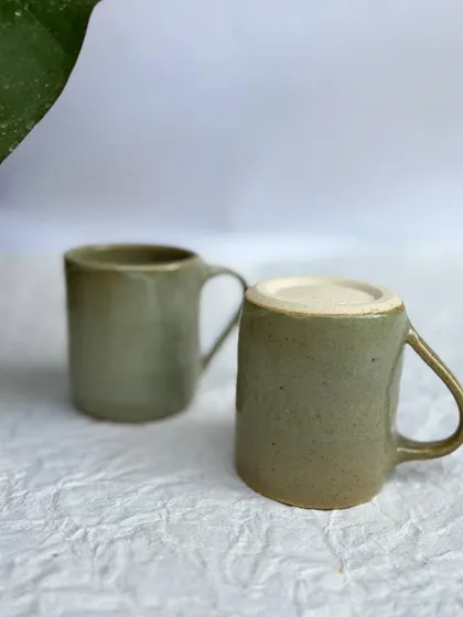Two of our Green Celadon mugs. This is a classic, versatile glaze that looks great on any form.