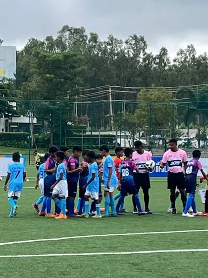 A team huddle on the pitch during the DPDL Super Cup.