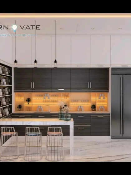 A luxurious open-concept kitchen with dark wood grain cabinets and a marble island with bar seating. The design includes illuminated glass-front cabinets and a built-in wine rack, perfect for entertaining.