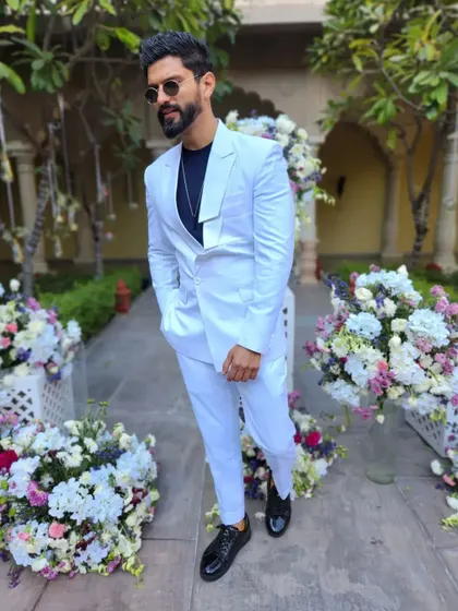 A crisp, all-white suit, perfect for a daytime event or a white-themed party.