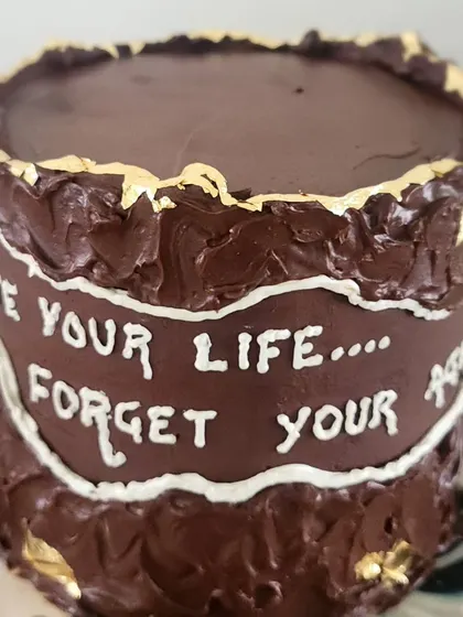 This one is for the true chocolate lovers. It's a tall cake with layers of dark chocolate ganache on the inside and a rich, textured coating on the outside, finished with a fun, personalized message.