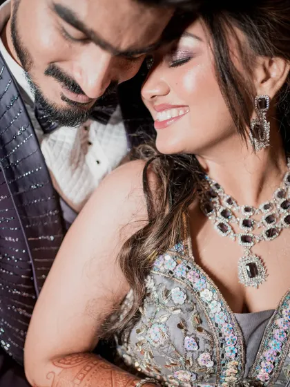 A close-up that captures pure joy. The bride's radiant smile and sparkling eye makeup are the highlights of this beautiful reception moment.