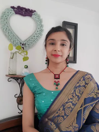 This beaded necklace set with a fabric pendant is perfect for both Navratri and other festive events. The combination of red, green, and black beads with small ghungroos adds a playful touch to any outfit.