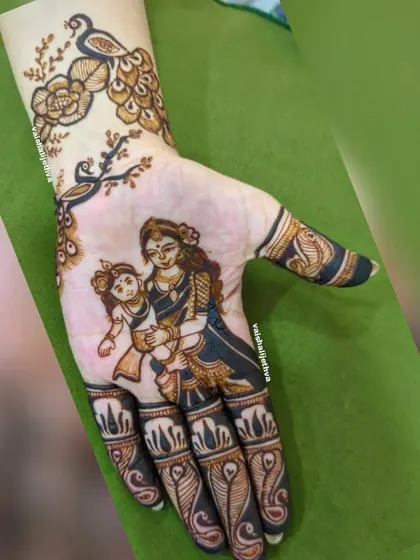 A beautiful baby shower design inspired by Krishna's childhood. It features mother Yashoda holding baby Krishna, with peacock and floral details.