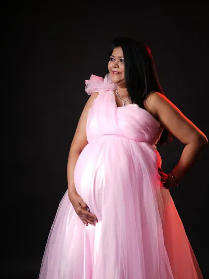 A beautiful portrait of a mom-to-be in my pink maternity gown. The lighting and pose create a stunning and powerful image.