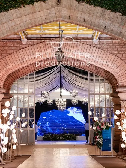 Another view of the entrance walkway, this time flanked by modern, geometric glass installations that reflect the light and add a contemporary touch.