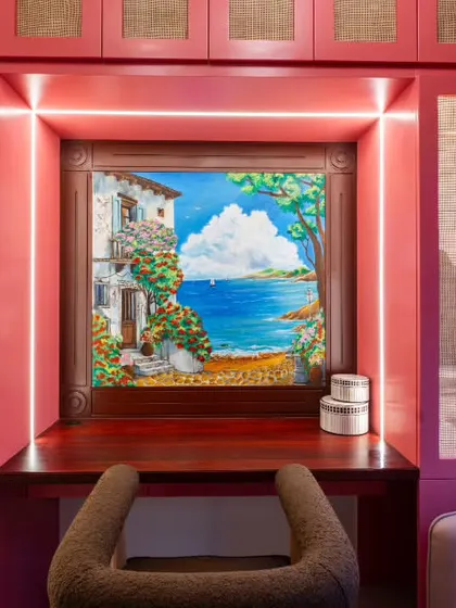 A detailed view of the coastal mural, framed perfectly within the custom cabinetry. The integrated lighting highlights the artwork, making it a captivating feature day or night.