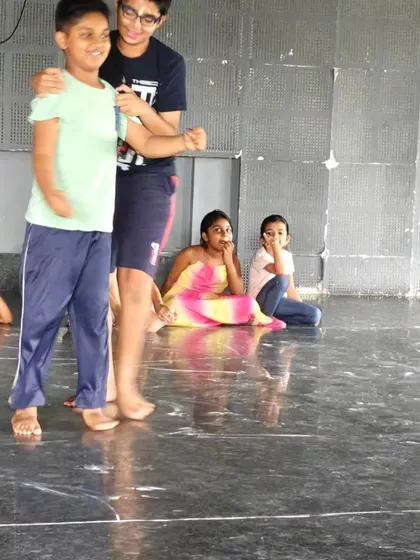 A duplicate image of two boys practicing a scene together during a rehearsal.