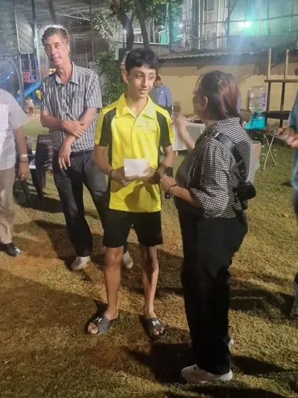Zehn Masani receiving his award for winning the Men's Singles Open, a significant achievement for a young player.