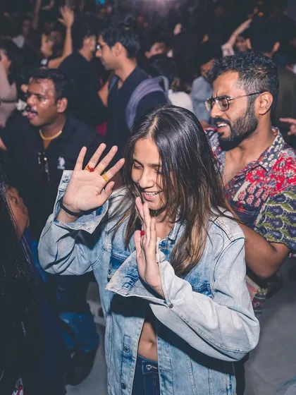 A couple smiling and dancing together on the floor. My music sets the mood for connection and fun.