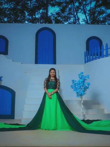 The two-tone green trail gown spread out to its full width. The combination of light and dark green adds depth and dimension to the outfit.