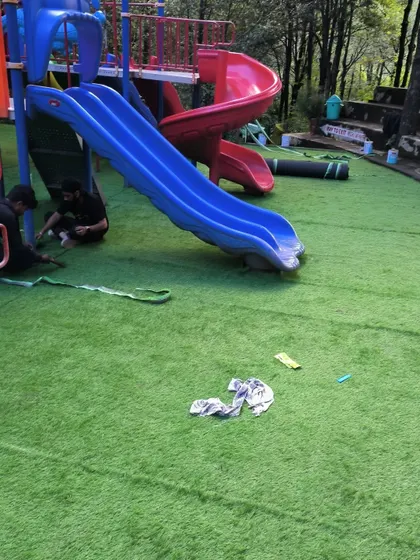 My team at work during the installation in Nainital. We ensure every seam is perfect and the entire surface is smooth and secure for kids to play on.