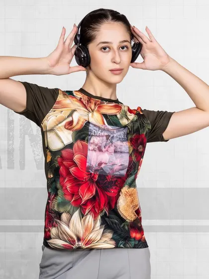 A model wearing a floral-printed athletic t-shirt and headphones, creating a modern and stylish look for a gym wear campaign.