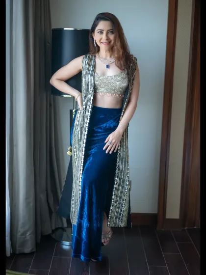 A confident full-length pose by a window. The model's stylish outfit and relaxed posture create a sophisticated and modern portrait.