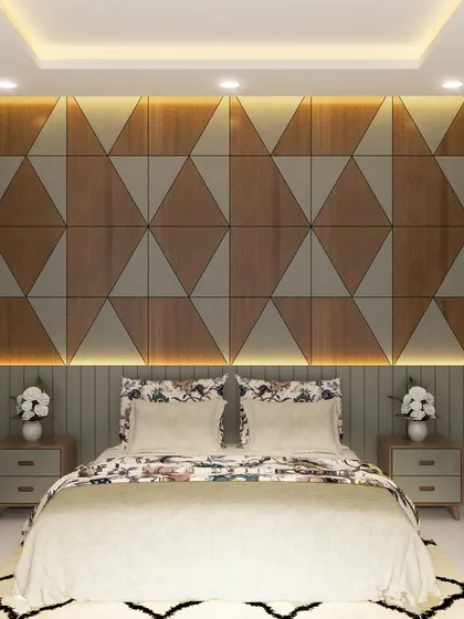 A bedroom design from a luxury project in Yelahanka, featuring a geometric wood and fabric paneled headboard wall. The integrated backlighting creates a warm and inviting focal point.