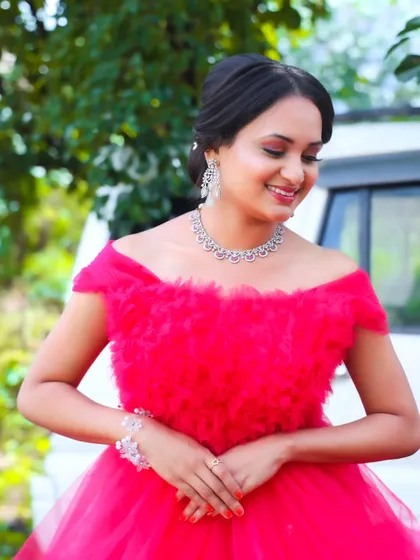 A sweet, smiling shot. The soft makeup enhances her natural features, creating a look that is both glamorous for the photoshoot and feels authentically her.