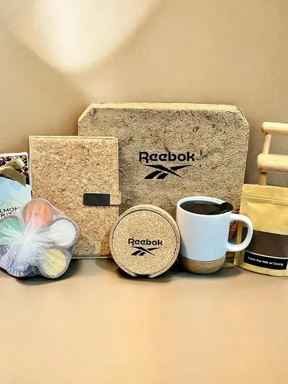 I partner with global brands like Reebok to create sustainable corporate gifts. This eco-friendly hamper features branded cork items and other treats, perfectly aligning with their brand values.